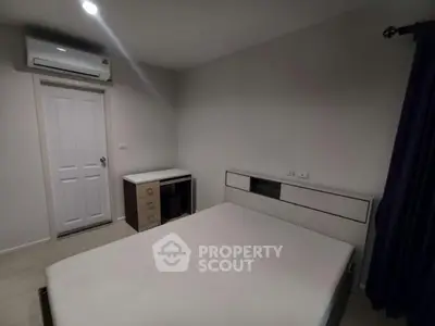 Modern minimalist bedroom with sleek furniture and air conditioning