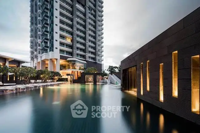 Luxurious high-rise building with stunning pool and modern architecture.