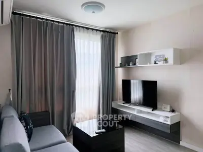 Modern living room with sleek furniture and large window