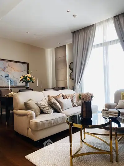 Luxurious living room with elegant decor, plush seating, and abundant natural light from large windows.