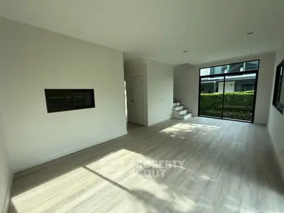 Spacious modern living room with large windows and natural light