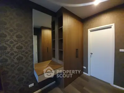 Elegant bedroom with built-in wardrobe and stylish wallpaper
