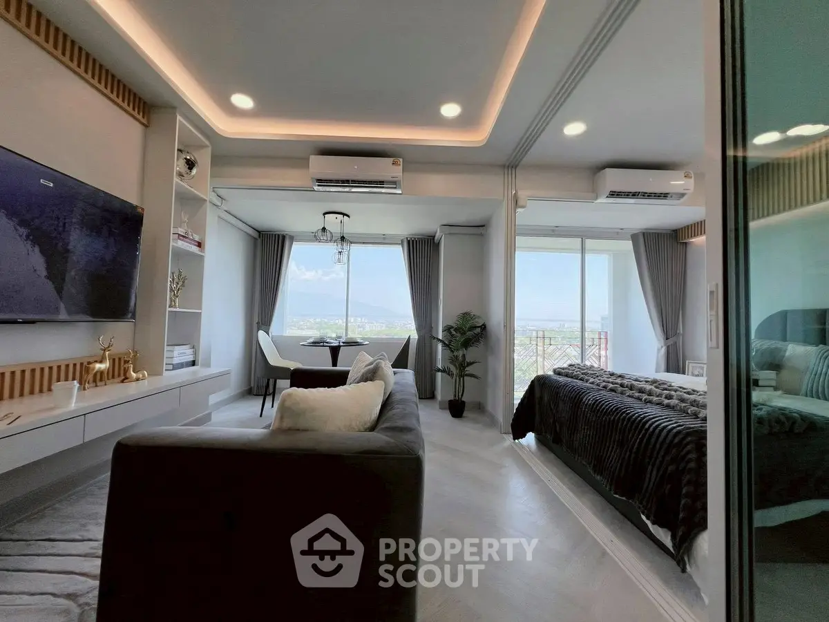 Modern open-plan living room with mountain view and cozy bedroom