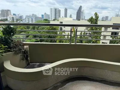 Spacious balcony with city skyline view, perfect for relaxation and enjoying urban living.