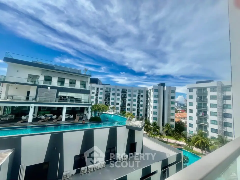 Luxurious modern apartment complex with stunning rooftop pool and panoramic views.