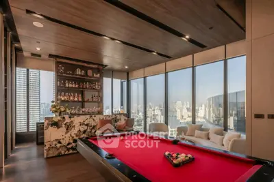 Luxurious high-rise living room with pool table and city skyline view