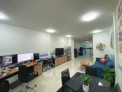 Spacious modern living room with home office setup and stylish decor