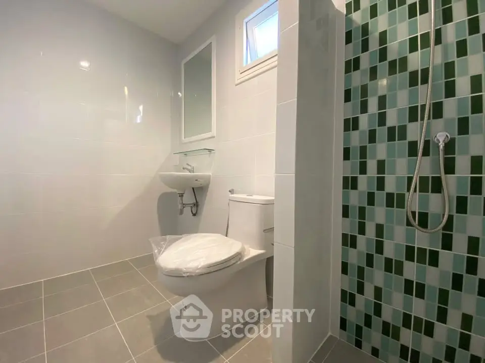 Modern bathroom with tiled shower and sleek fixtures
