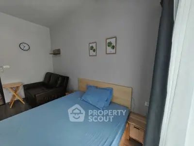 Cozy bedroom with modern decor and comfortable furnishings in a stylish apartment.
