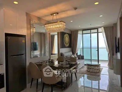 Luxurious living room with ocean view, elegant dining area, and modern decor in a high-rise apartment.