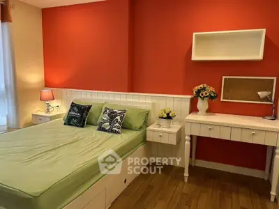 Charming bedroom with vibrant orange accent wall and cozy decor
