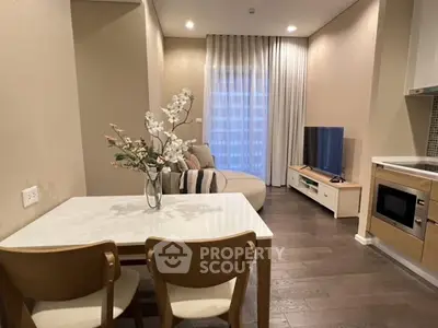 Modern living room with cozy seating, dining area, and stylish decor in a contemporary apartment.