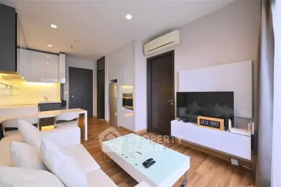 Modern living room with sleek design, open kitchen layout, and stylish furnishings in a contemporary apartment.