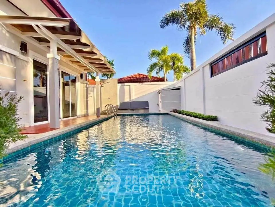 Luxurious private villa with sparkling pool and tropical landscaping, perfect for relaxation and entertaining.