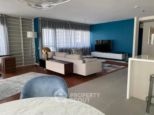 Spacious modern living room with stylish decor and large windows