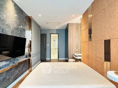 Luxurious modern bedroom with stylish decor and wall-mounted TV