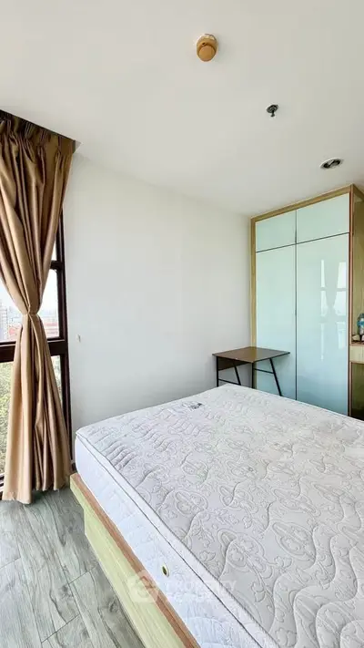 Bright bedroom with large window and modern furnishings