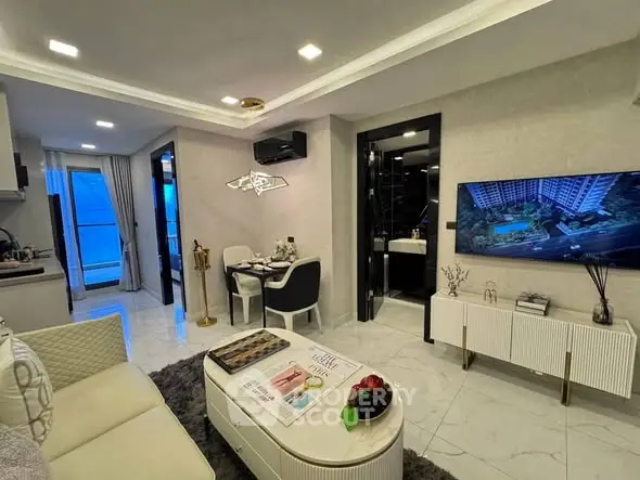 Modern living room with open kitchen and stylish decor in a cozy apartment.