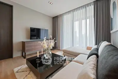 Modern living room with sleek furniture and large windows offering natural light.