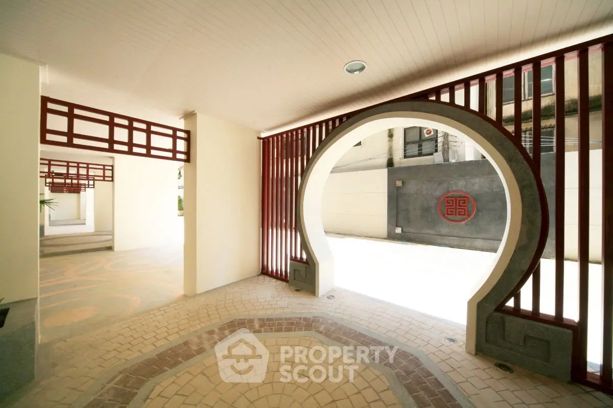 Elegant entrance with unique circular archway and modern design elements.