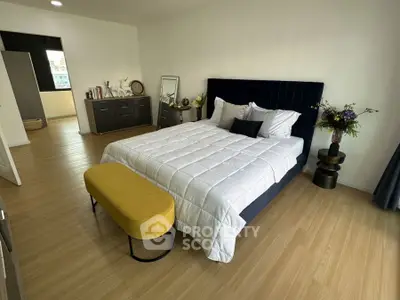 Spacious modern bedroom with elegant decor and natural light