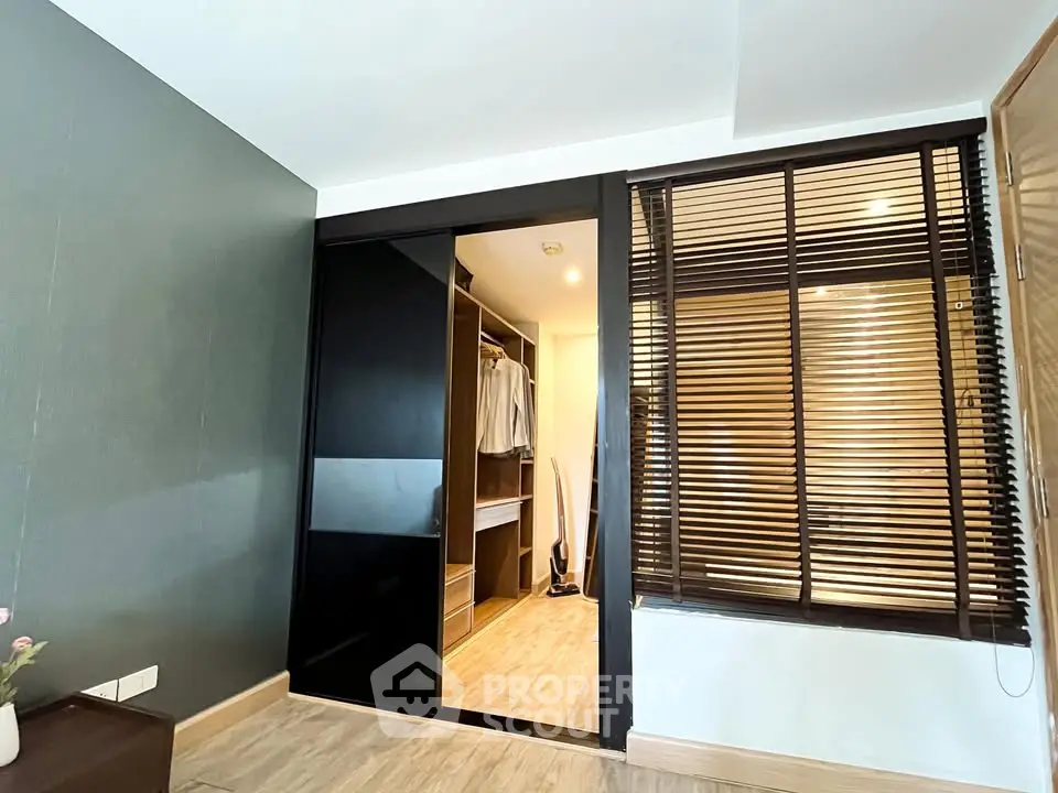 Modern bedroom with walk-in closet and stylish blinds