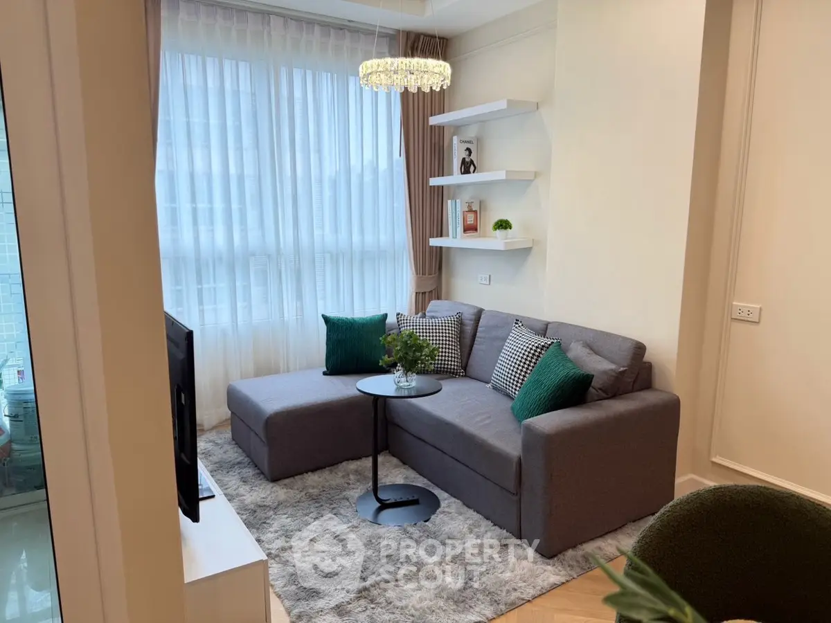 Cozy living room with modern gray sofa, chic decor, and natural light.