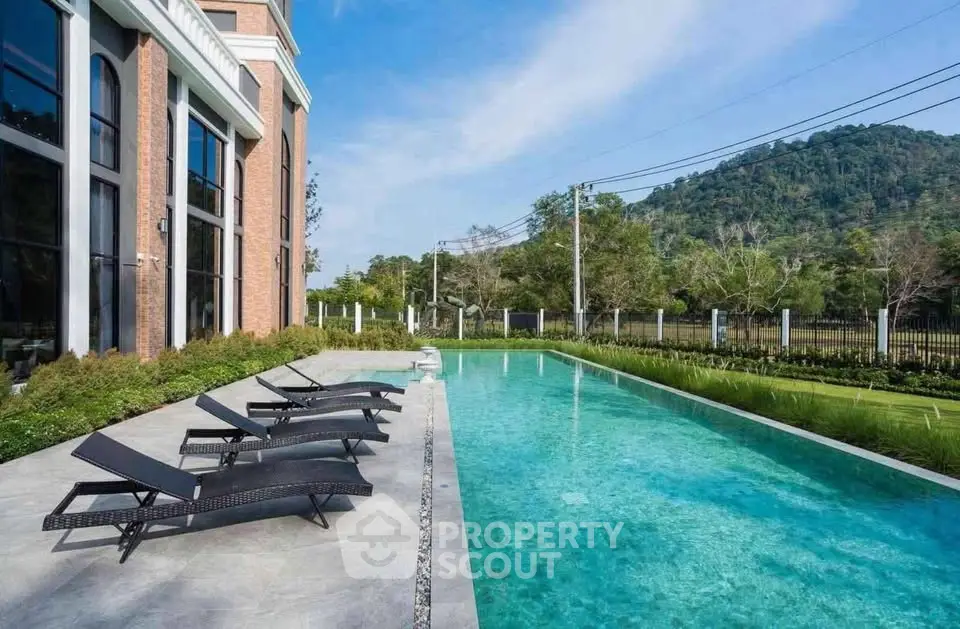Luxurious outdoor pool with scenic mountain view and modern architecture
