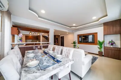 Luxurious open-plan living and dining area with elegant decor and modern lighting.
