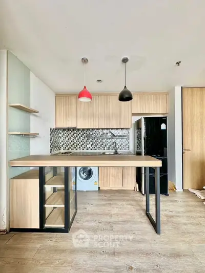 Modern kitchen with stylish backsplash and built-in washing machine