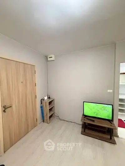 Cozy living room with modern TV setup and wooden accents