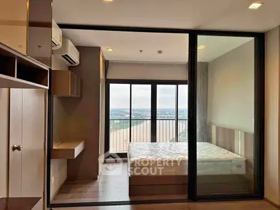 Modern bedroom with large windows offering stunning city view, featuring sleek design and ample natural light.