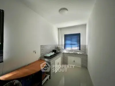 Compact kitchen with modern appliances and natural light