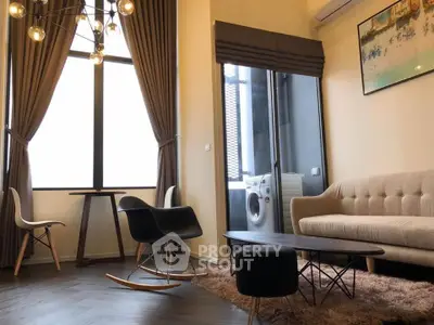 Modern living room with stylish furniture and large windows