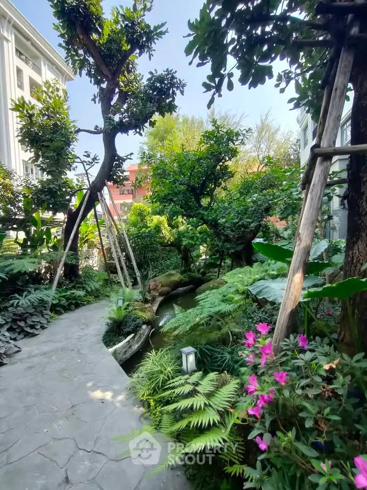 Lush garden pathway with vibrant greenery and flowers in a serene residential setting.