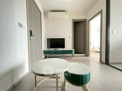 Modern living room with sleek furniture and wall-mounted air conditioning unit.