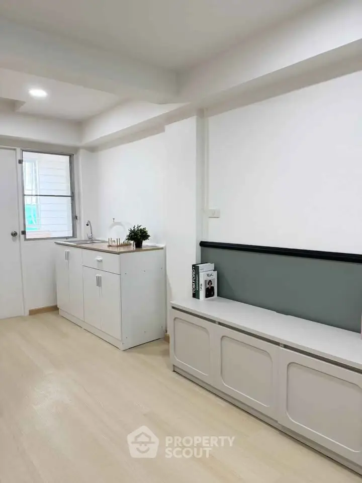 Bright and modern interior with sleek cabinetry and natural light, perfect for urban living.