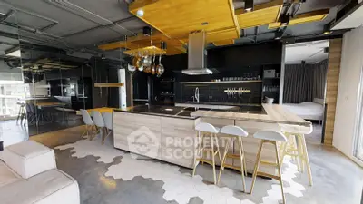 Modern open-layout kitchen with sleek design and stylish bar seating