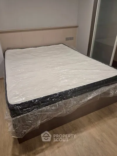 Spacious bedroom with new mattress and modern flooring, ideal for comfort and relaxation.