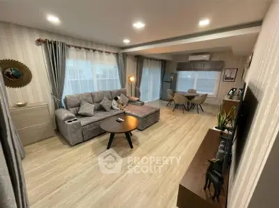 Spacious modern living room with stylish decor and large windows