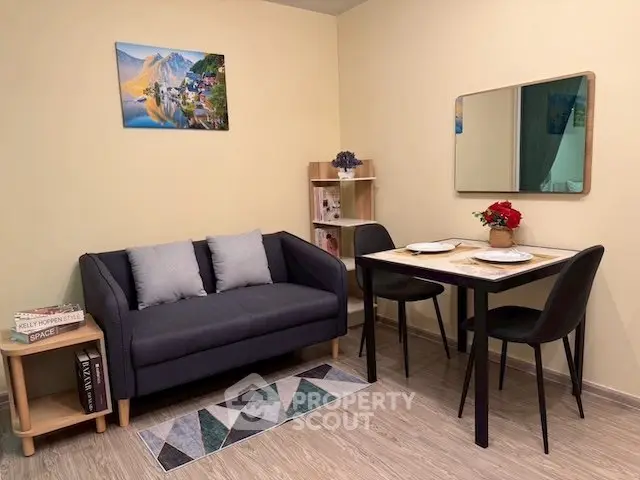 Cozy living room with modern decor, featuring a stylish sofa and dining area, perfect for urban living.