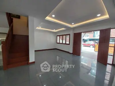 Spacious living room with modern lighting and large windows in a stylish home.