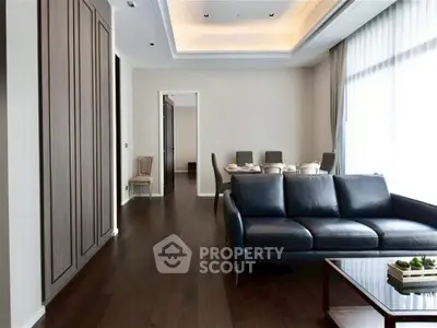 Elegant living room with dark wood flooring and modern furniture