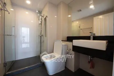 Modern bathroom with sleek fixtures and glass shower enclosure
