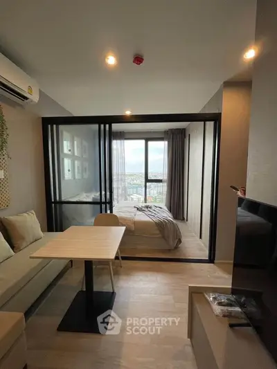 Modern studio apartment with glass partition and city view