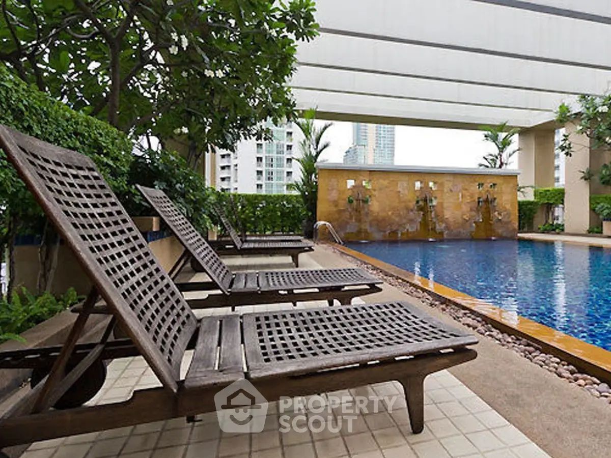 Luxurious rooftop pool with stylish loungers and city views, perfect for relaxation and leisure.