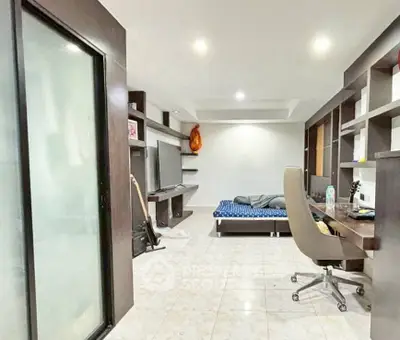 Modern bedroom with study area and sleek shelving, perfect for urban living.