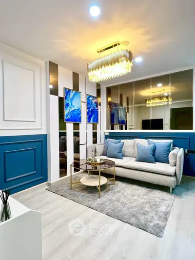 Luxurious living room with elegant decor, plush sofa, and modern chandelier in a stylish apartment.