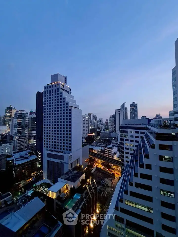 Stunning cityscape view from a high-rise building at dusk, showcasing urban architecture and skyline.