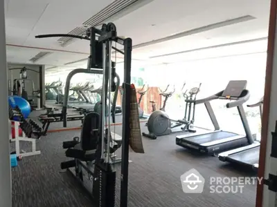 Modern gym with state-of-the-art fitness equipment in luxury apartment building